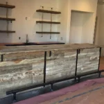 Wood counter and bar in basement with metal foot rest