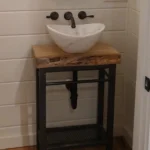 small freestanding wood vanity with white bowl sink