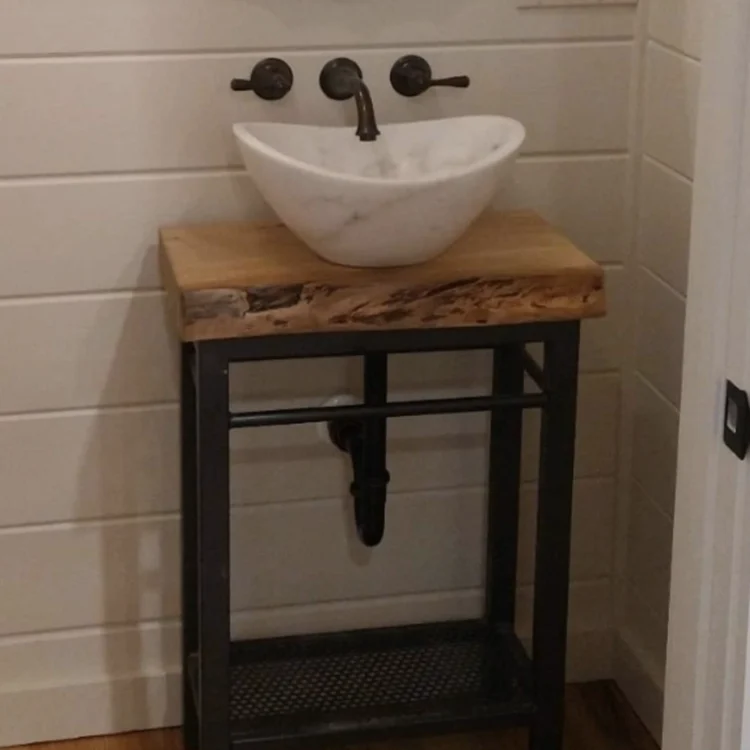 small freestanding wood vanity with white bowl sink