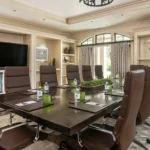 executive wood conference table with leather chairs