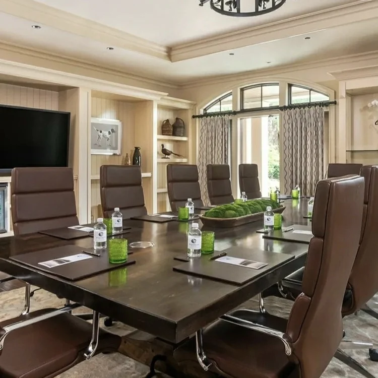 executive wood conference table with leather chairs