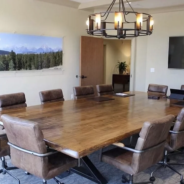 wood top conference table with leather chairs