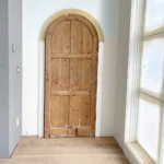 Natural wood interior door with arched top