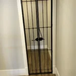 Narrow wine cellar entry interior doors made of metal
