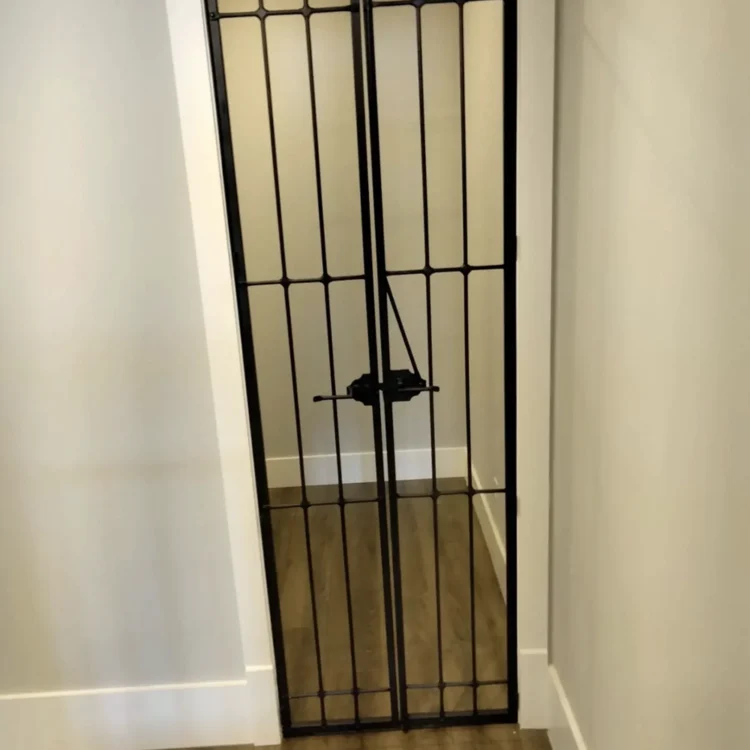 Narrow wine cellar entry interior doors made of metal