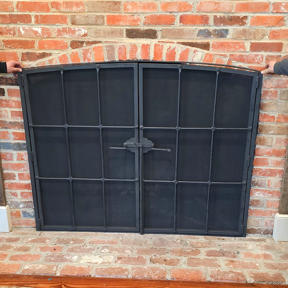 Custom fireplace screen with brick hearth