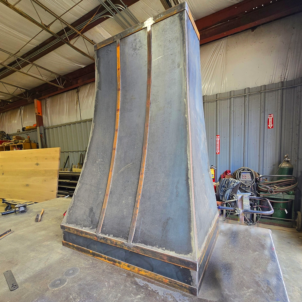 Progress shot of a metal hood vent in the shop