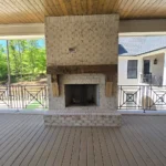 outdoor entertainment fireplace on covered porch