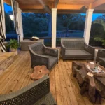 Exotic wood tables on high-end porch with outdoor seating