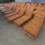Rows of teak lawn chairs for an exclusive hotel for outdoor seating
