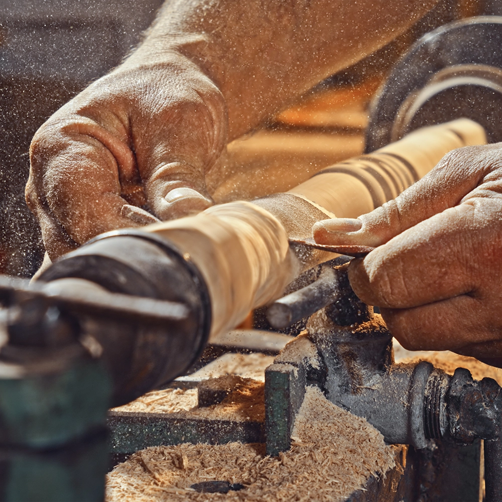 hand working on wooden spindle